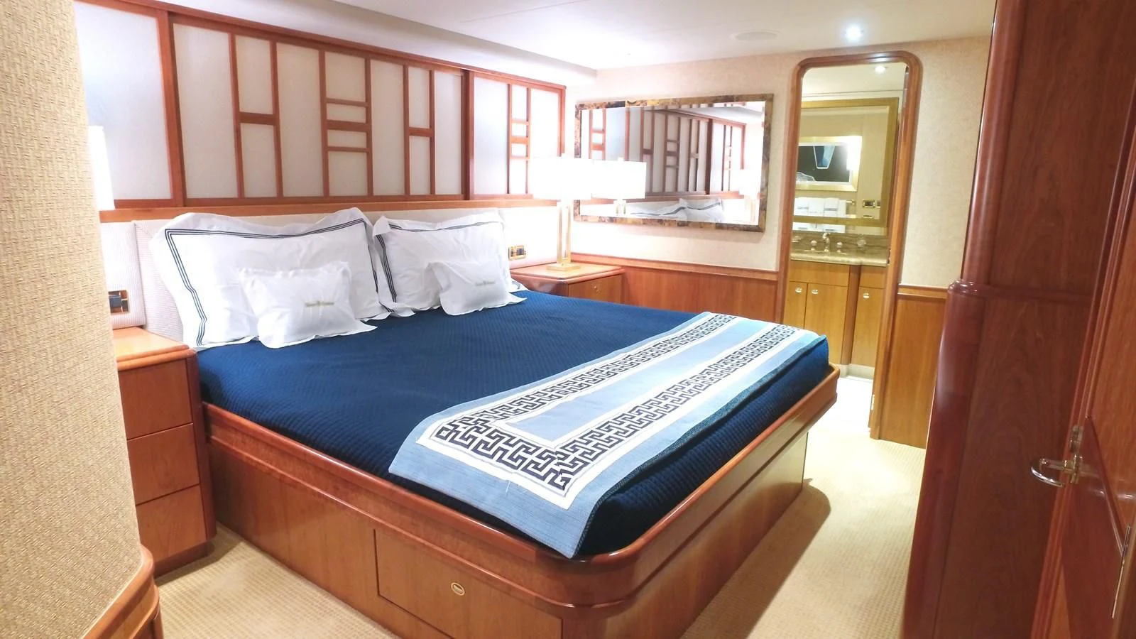 a bed with a blue sheet aboard ELYSIAN Yacht for Sale