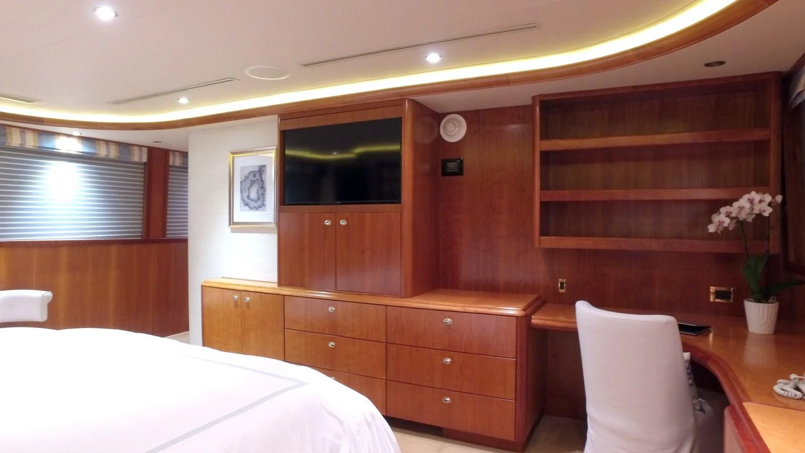 a room with a bed and a tv aboard ELYSIAN Yacht for Sale