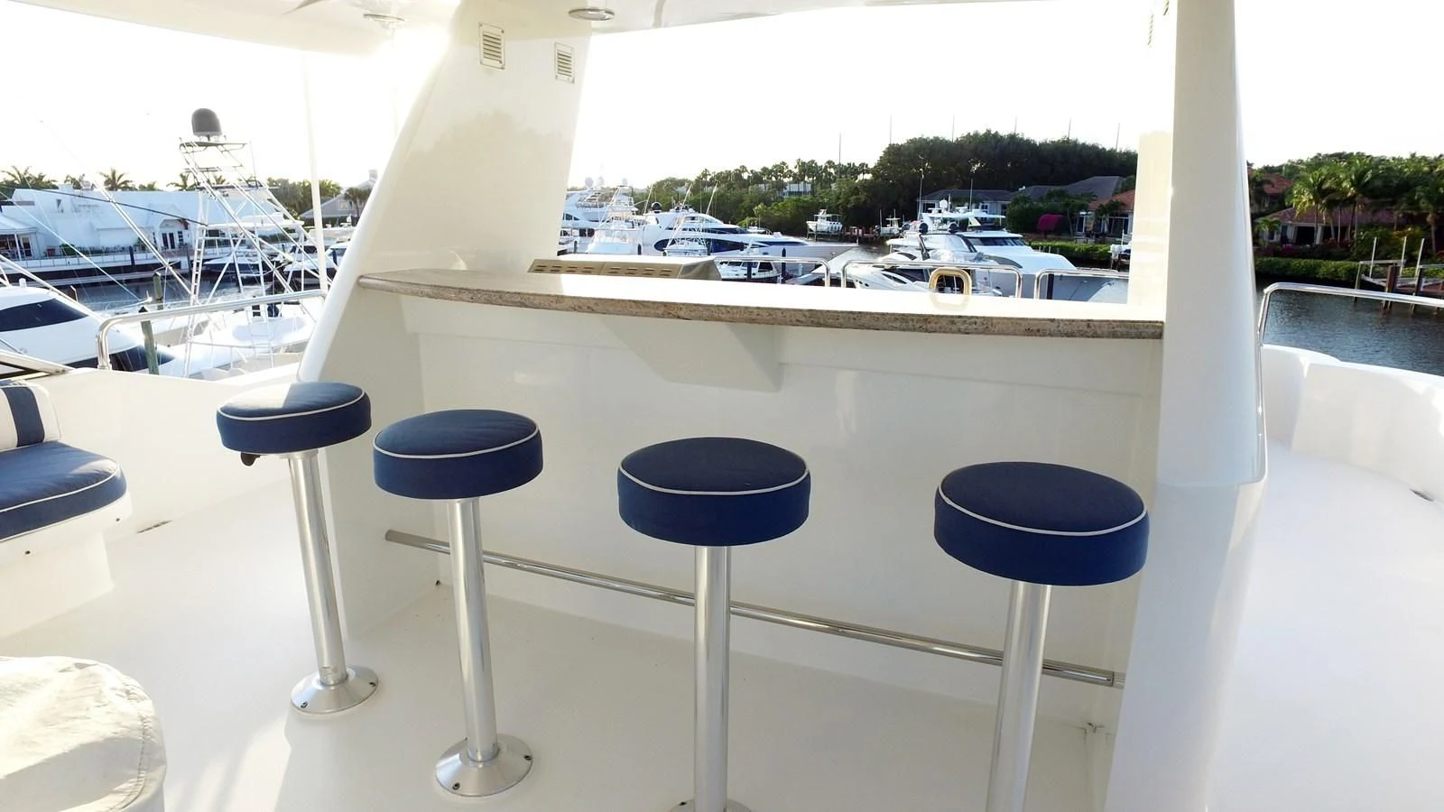 a group of stools on a balcony overlooking a parking lot aboard ELYSIAN Yacht for Sale