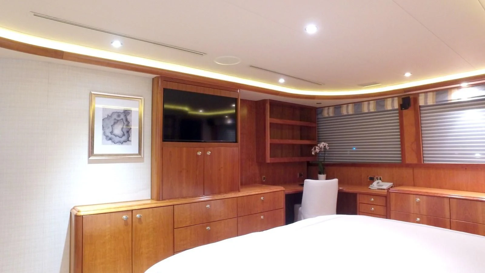 a room with a bed and a television aboard ELYSIAN Yacht for Sale