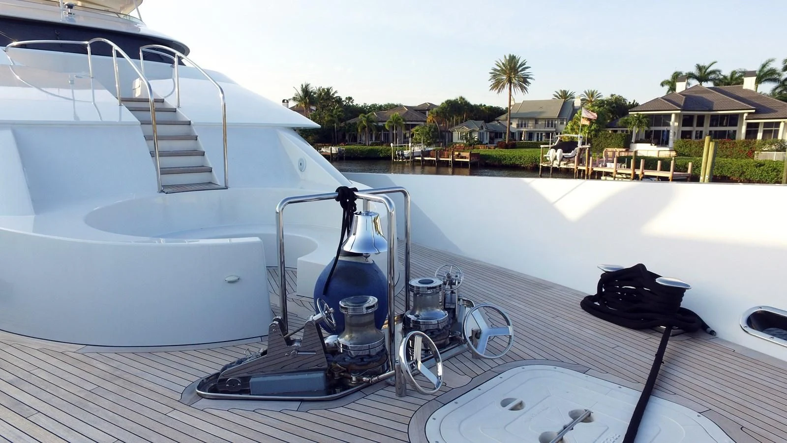 a deck with a boat and a water bottle on it aboard ELYSIAN Yacht for Sale