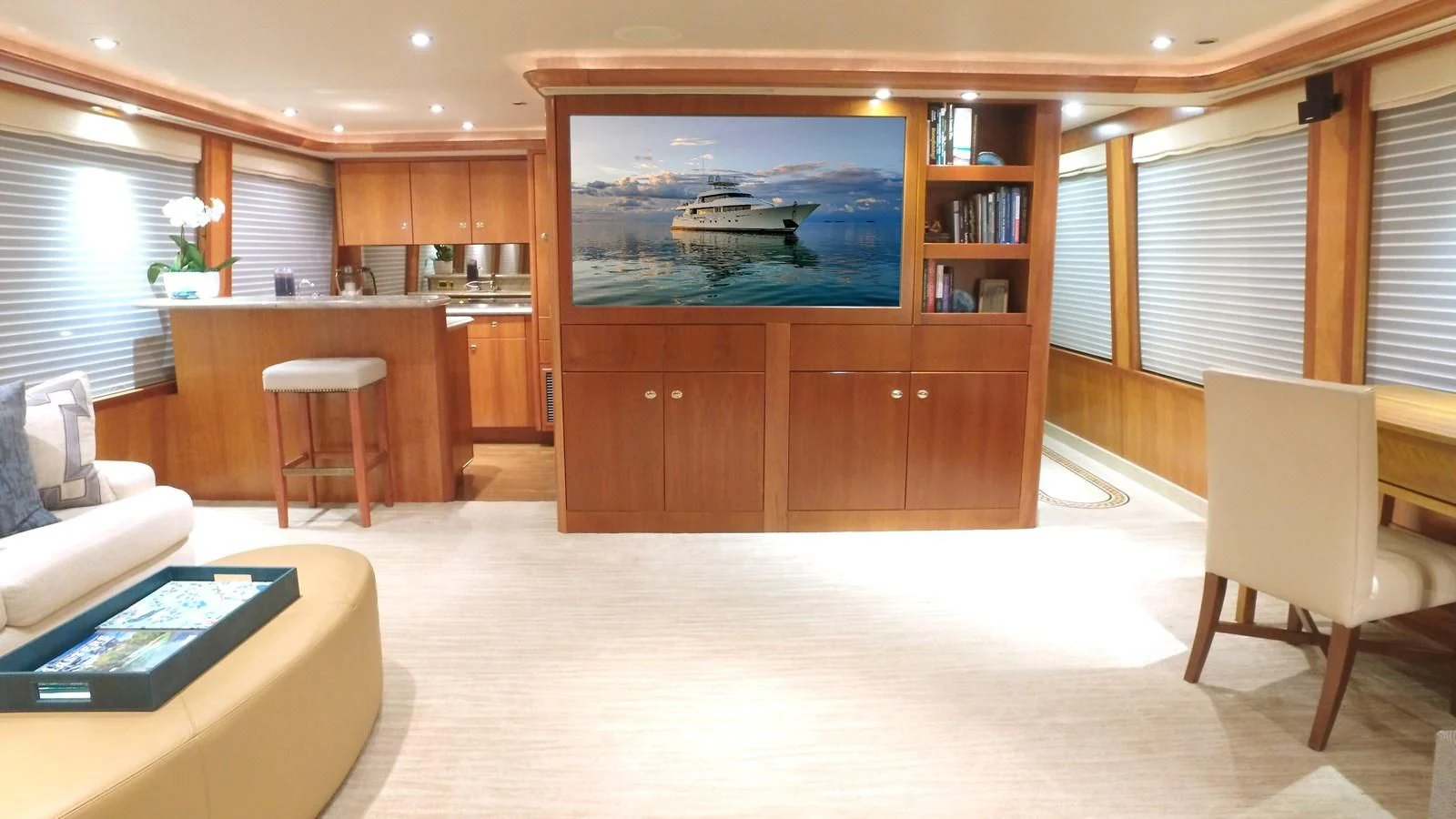 a room with a tv and a table and chairs aboard ELYSIAN Yacht for Sale
