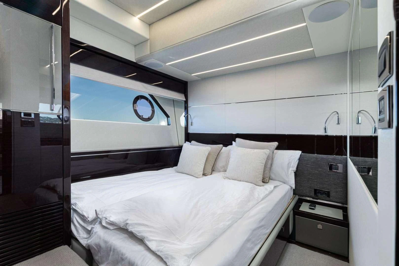 a room with a bed and a mirror aboard H Yacht for Sale