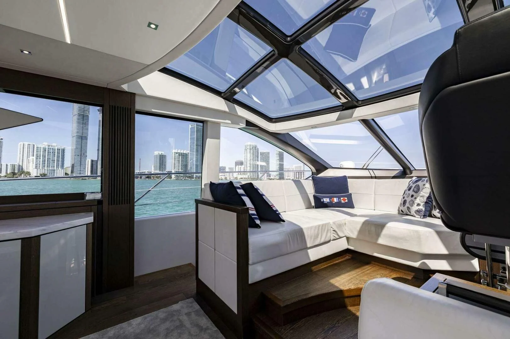a room with a bed and a view of the city aboard H Yacht for Sale
