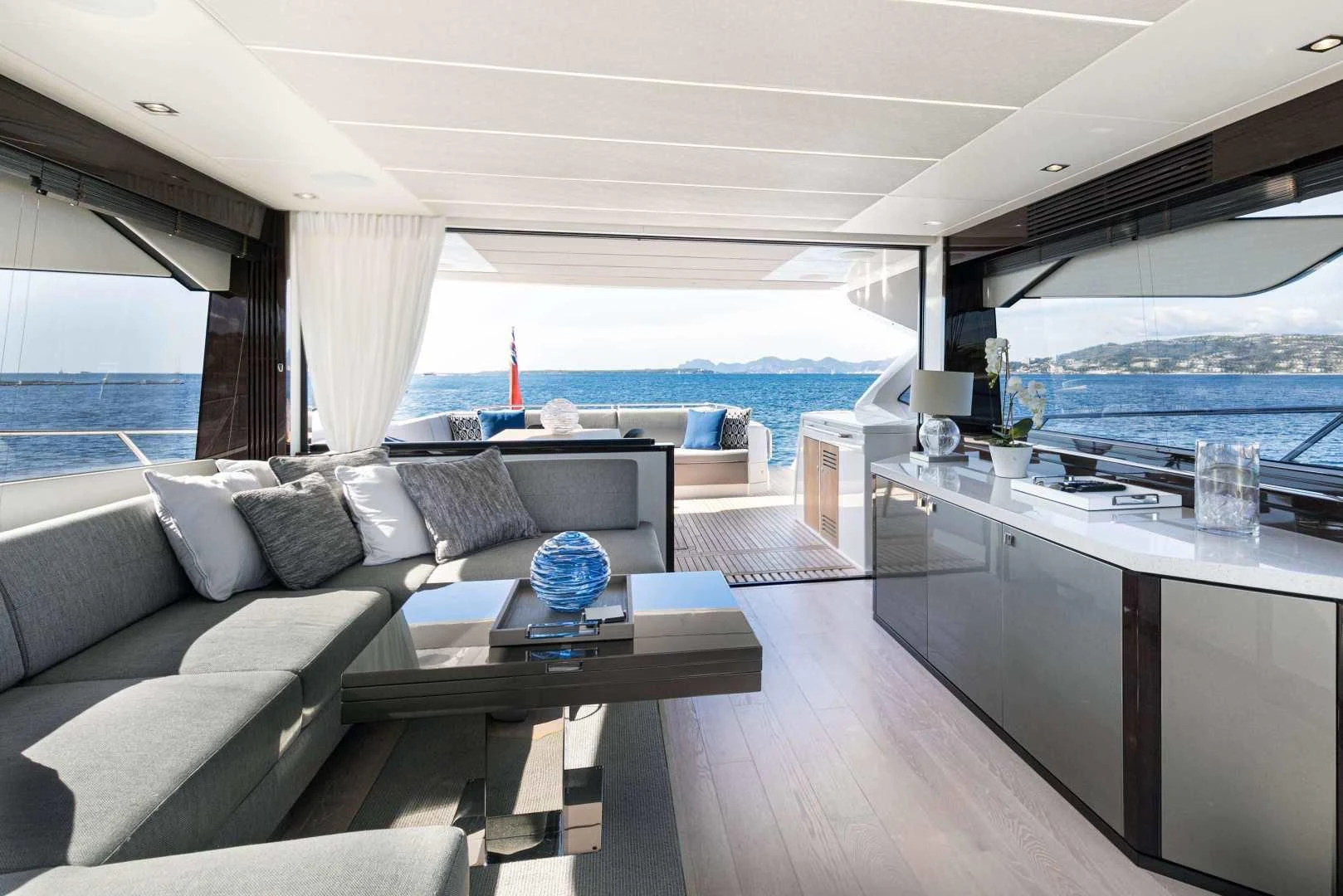 a living room with a large window aboard H Yacht for Sale