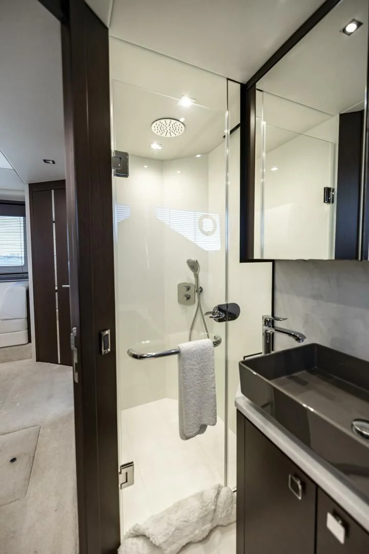 a bathroom with a glass shower aboard H Yacht for Sale