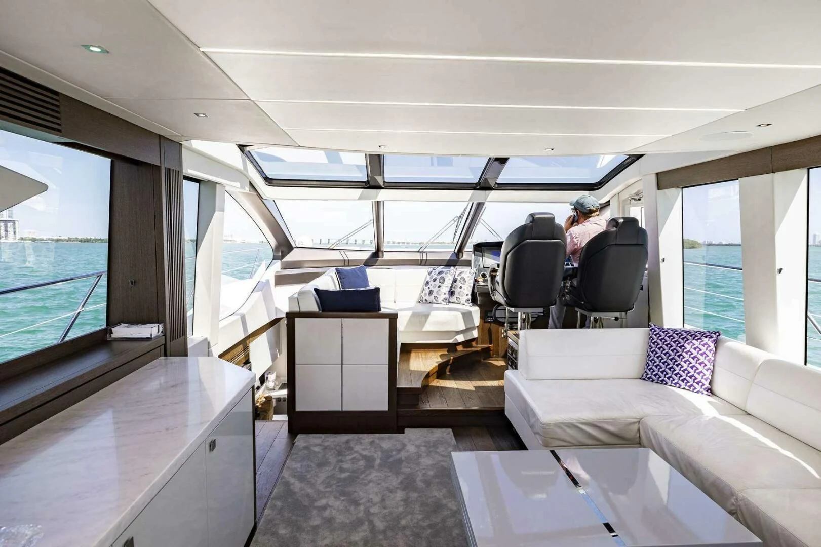inside of a vehicle with a large window and a view of the water aboard H Yacht for Sale