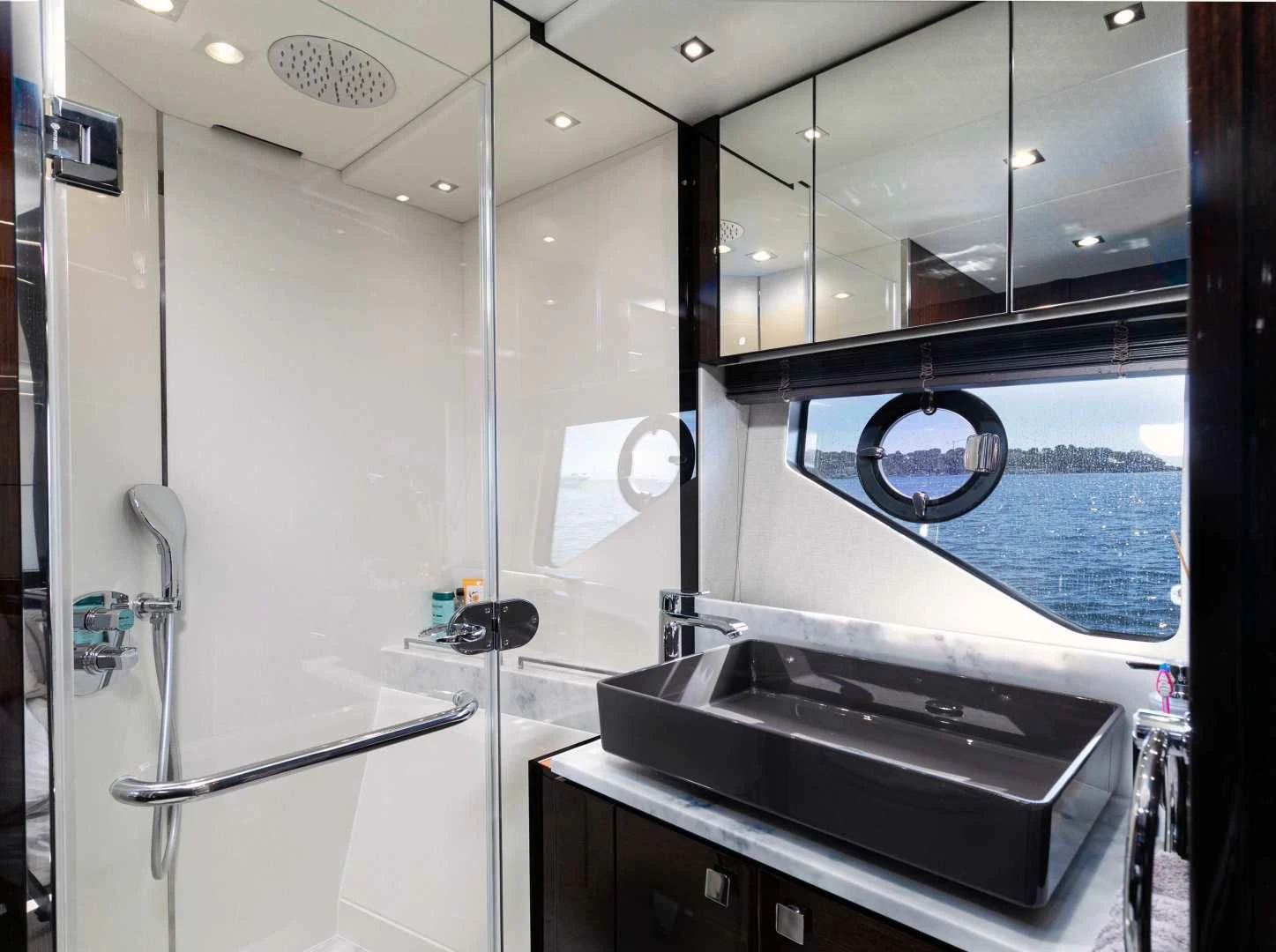 a large bathroom with a large glass shower unit aboard H Yacht for Sale