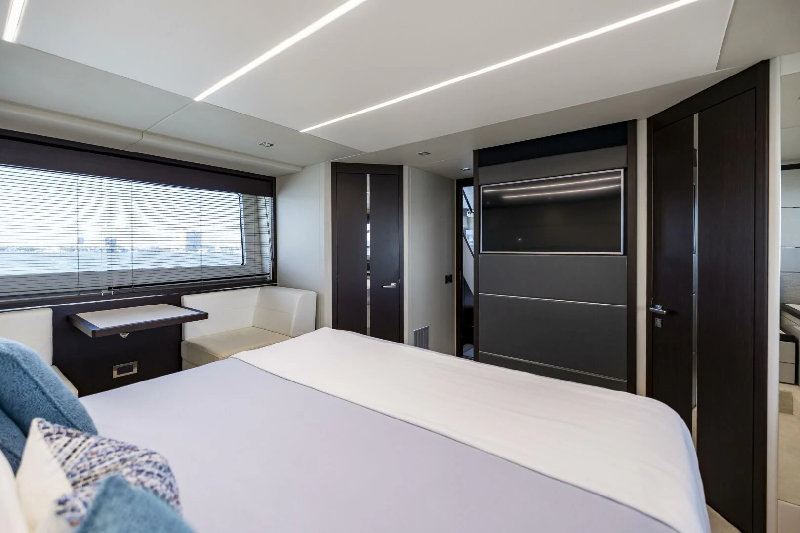 a bedroom with a bed and a desk aboard H Yacht for Sale