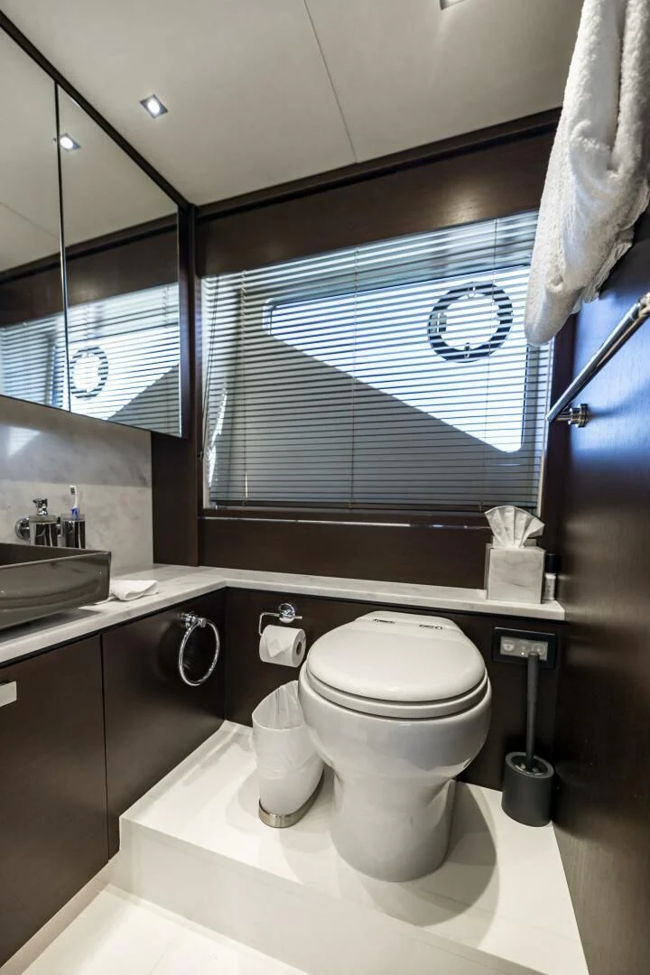 a bathroom with a toilet and a sink aboard H Yacht for Sale