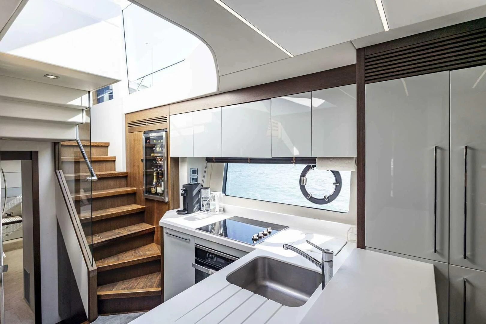 a kitchen with a sink and cabinets aboard H Yacht for Sale