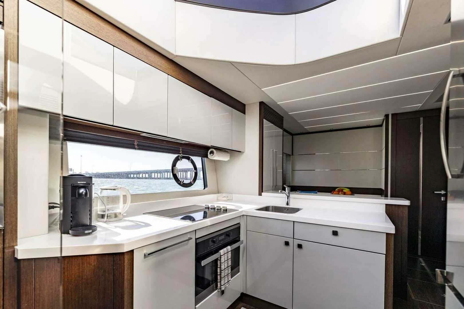 a kitchen with white cabinets aboard H Yacht for Sale