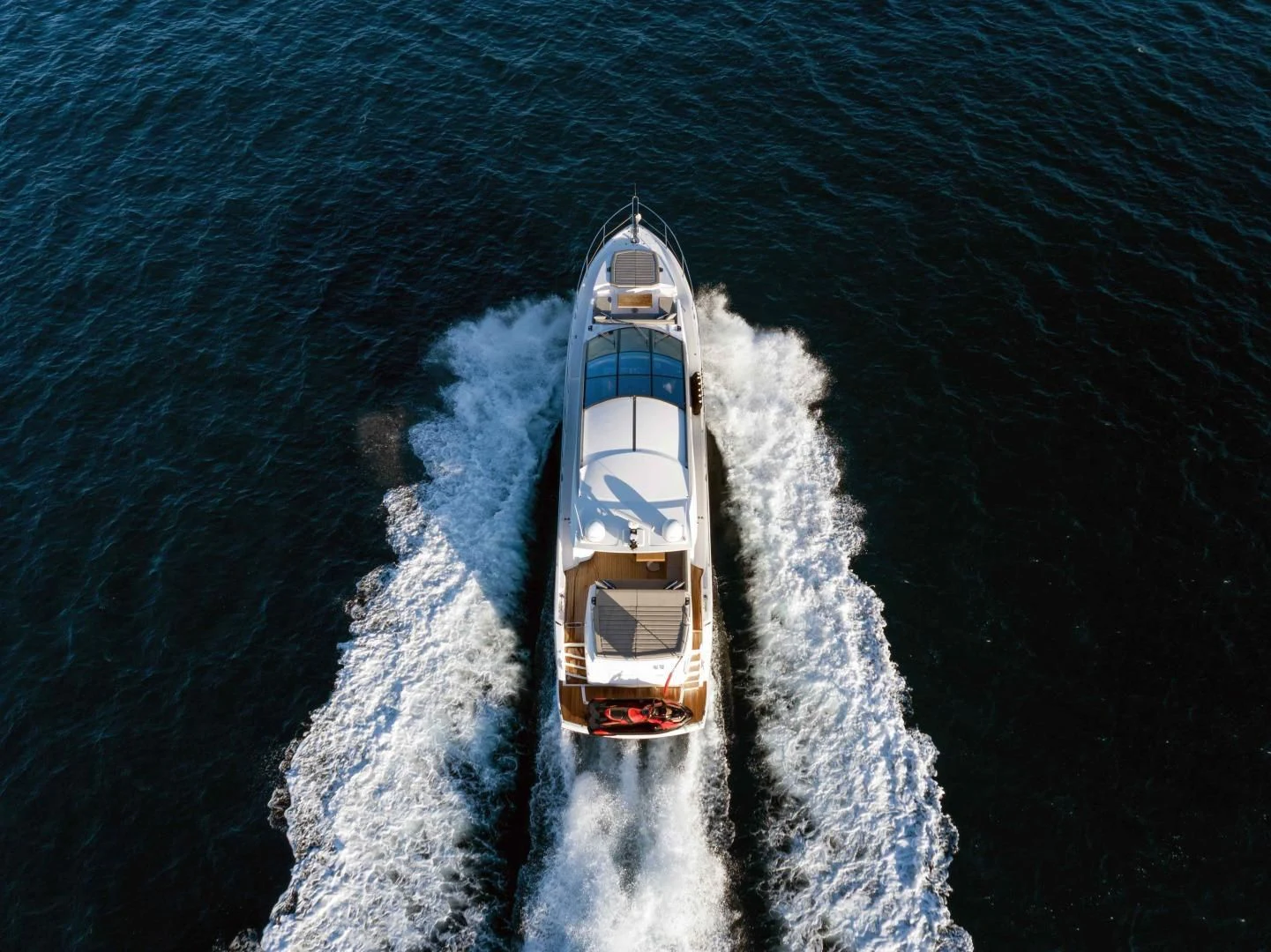 a white and blue boat in the water aboard H Yacht for Sale