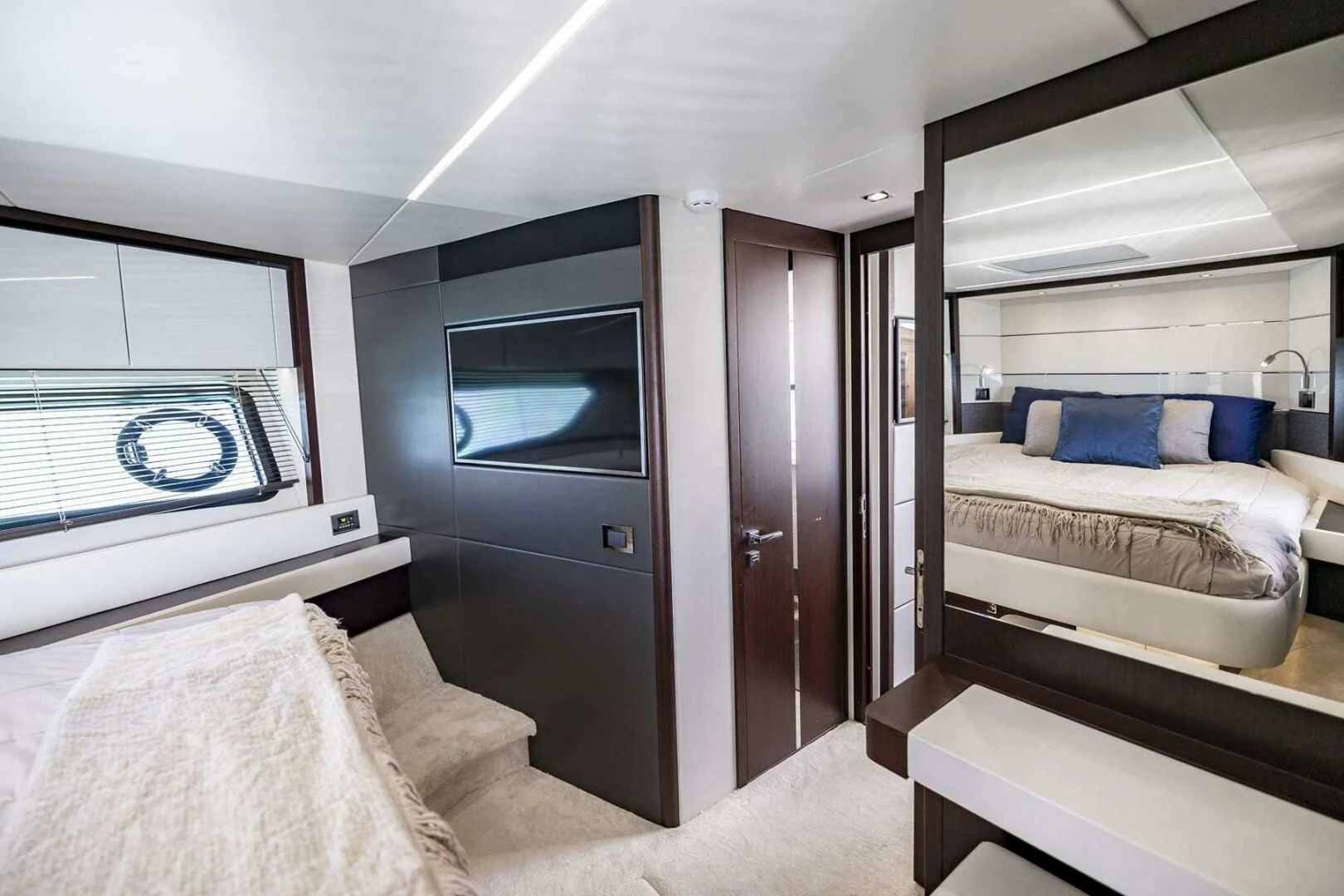 a room with a bed and a television aboard H Yacht for Sale