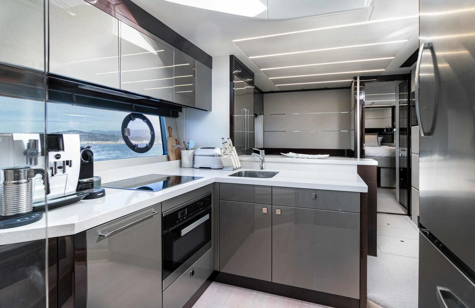 a kitchen with white cabinets aboard H Yacht for Sale