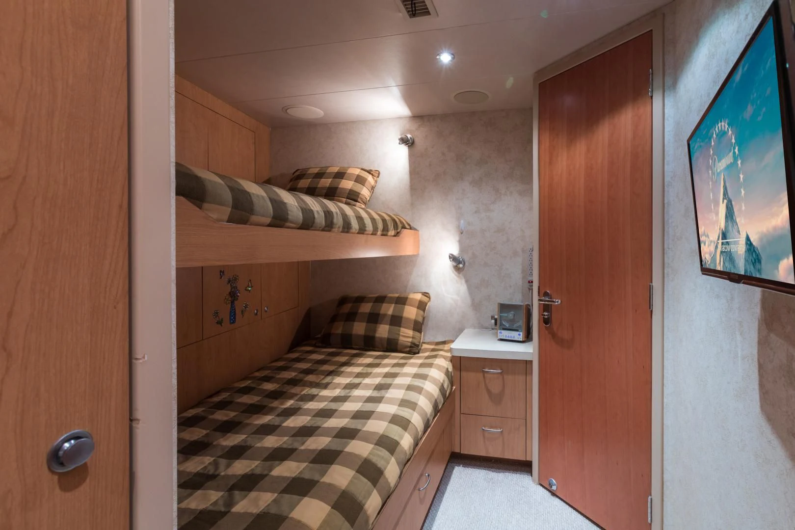 a bedroom with a bed and a desk aboard SHOGUN Yacht for Sale