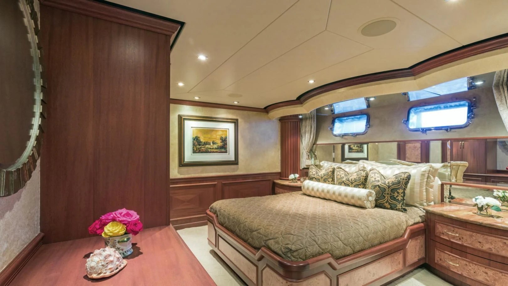a bedroom with a bed and a table aboard SHOGUN Yacht for Sale