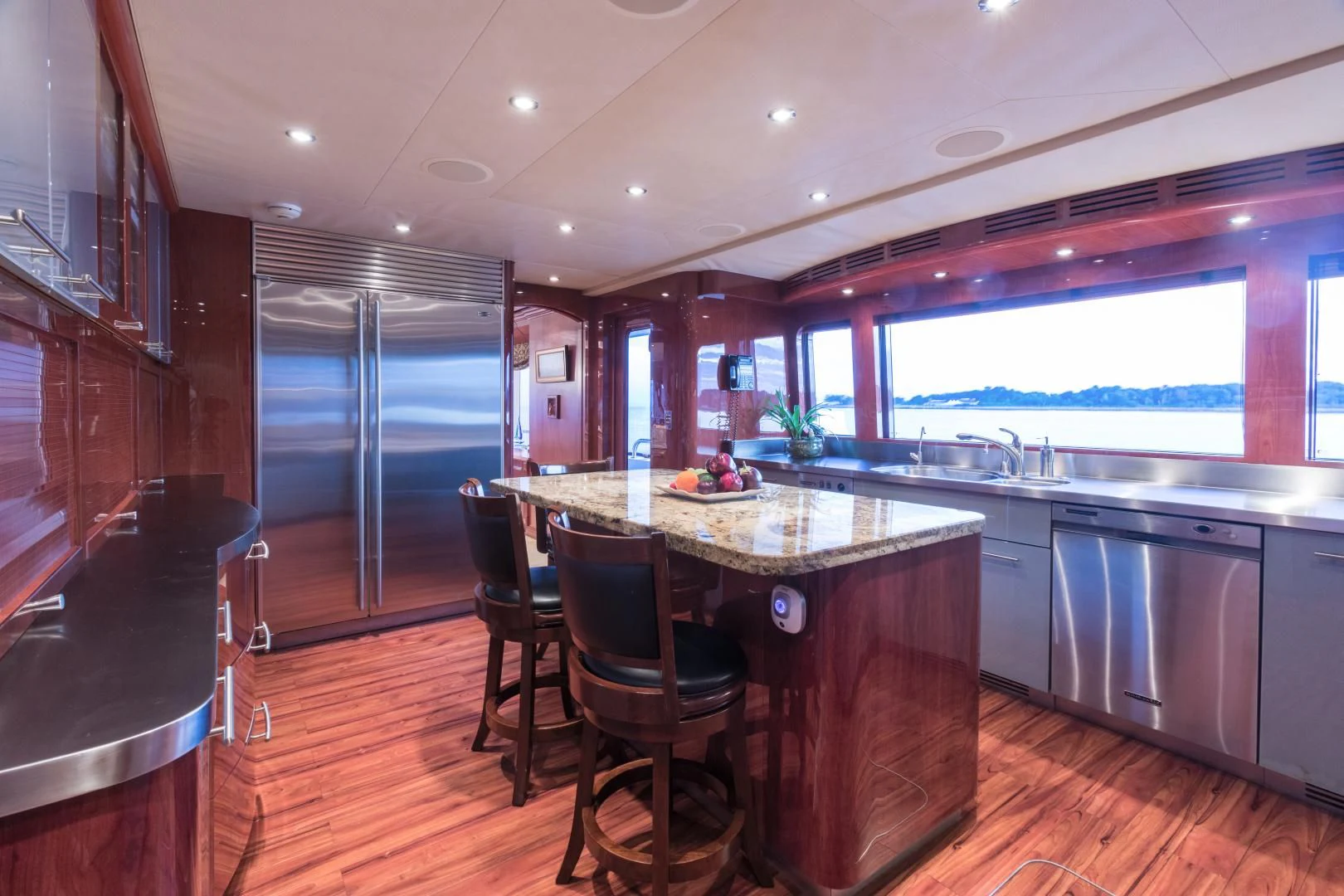 a kitchen with a bar stools and a bar stool aboard SHOGUN Yacht for Sale