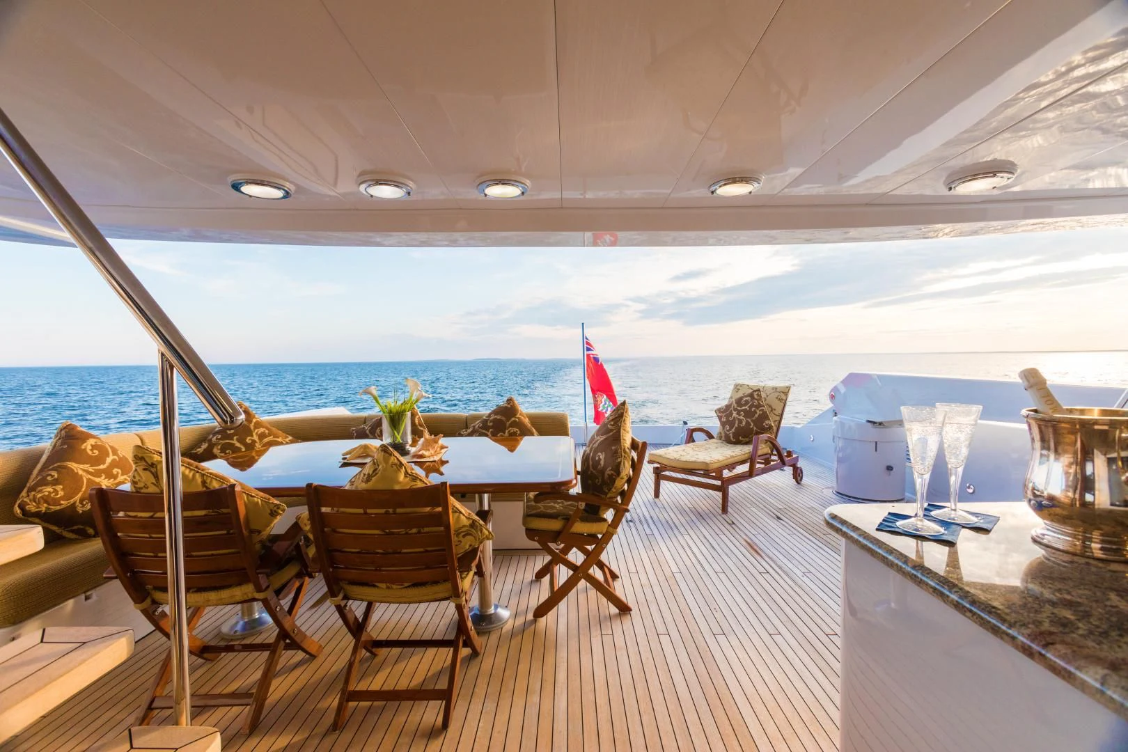 a room with a table chairs and a view of the ocean aboard SHOGUN Yacht for Sale