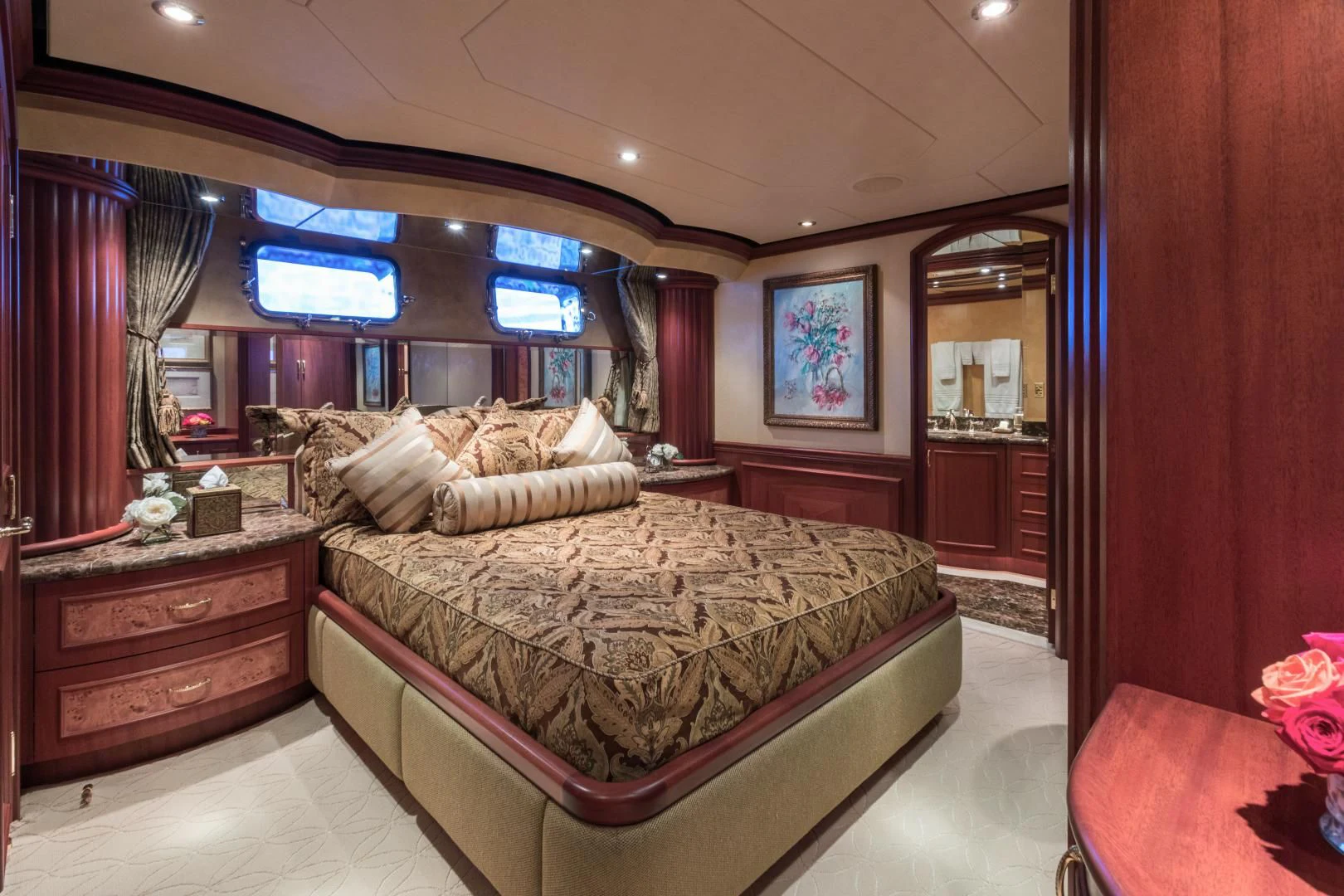 a bedroom with a bed and a mirror aboard SHOGUN Yacht for Sale