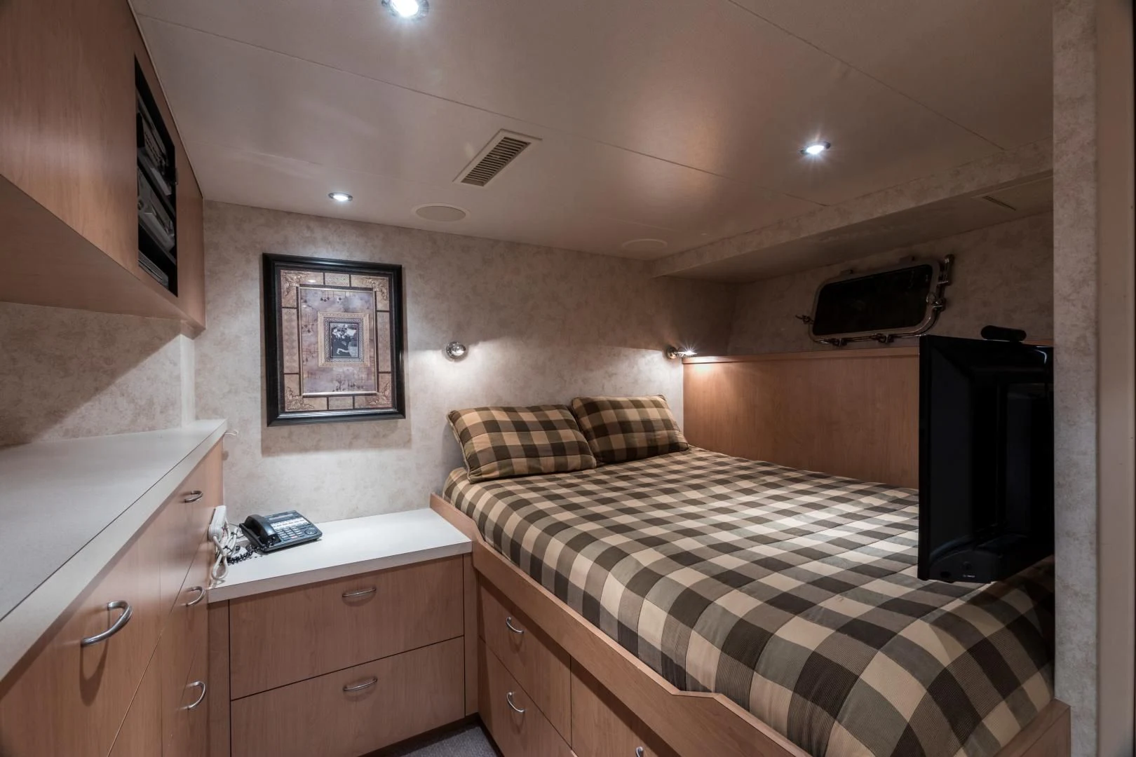 a bedroom with a bed and a television aboard SHOGUN Yacht for Sale