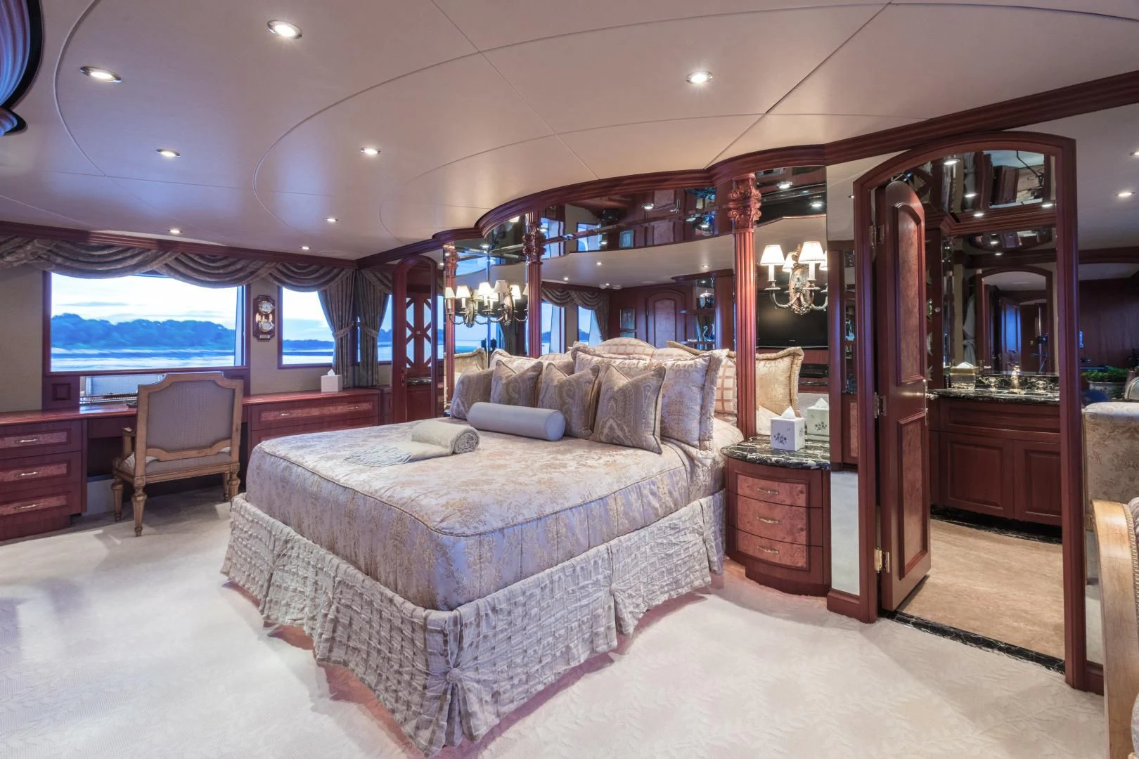 a bedroom with a bed and a chair aboard SHOGUN Yacht for Sale