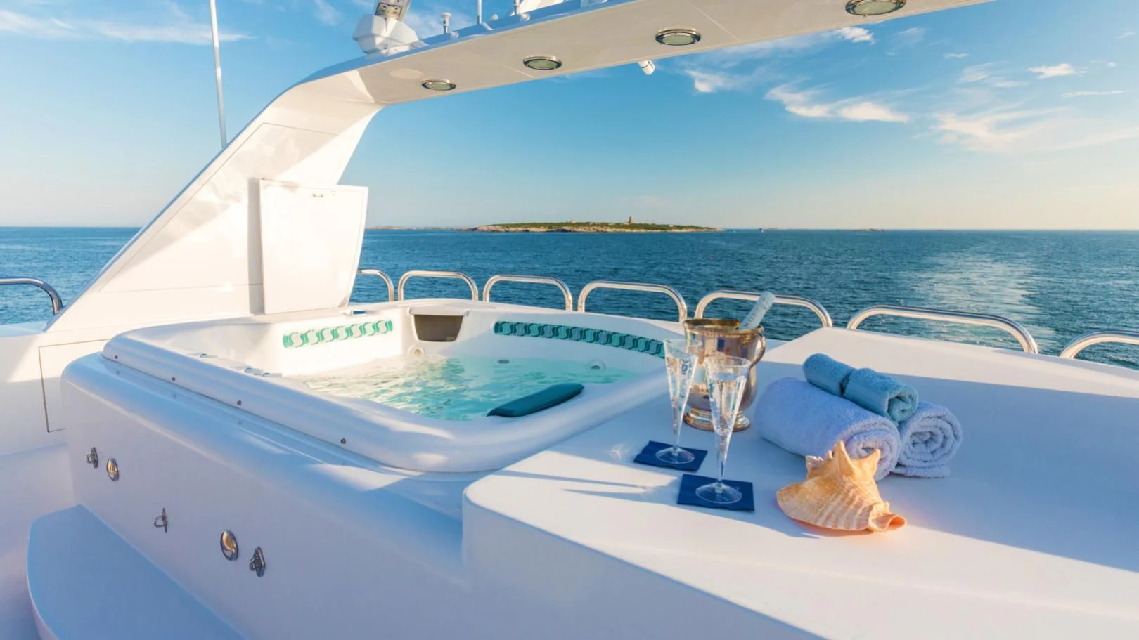 a boat with a glass table and a glass on the front aboard SHOGUN Yacht for Sale