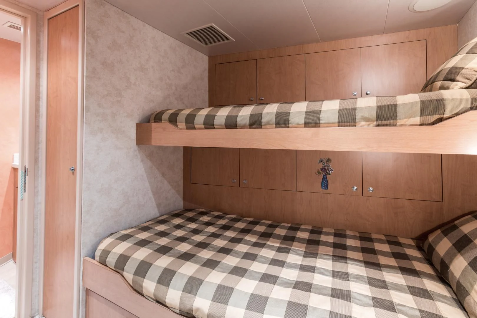 a bed with a striped sheet aboard SHOGUN Yacht for Sale