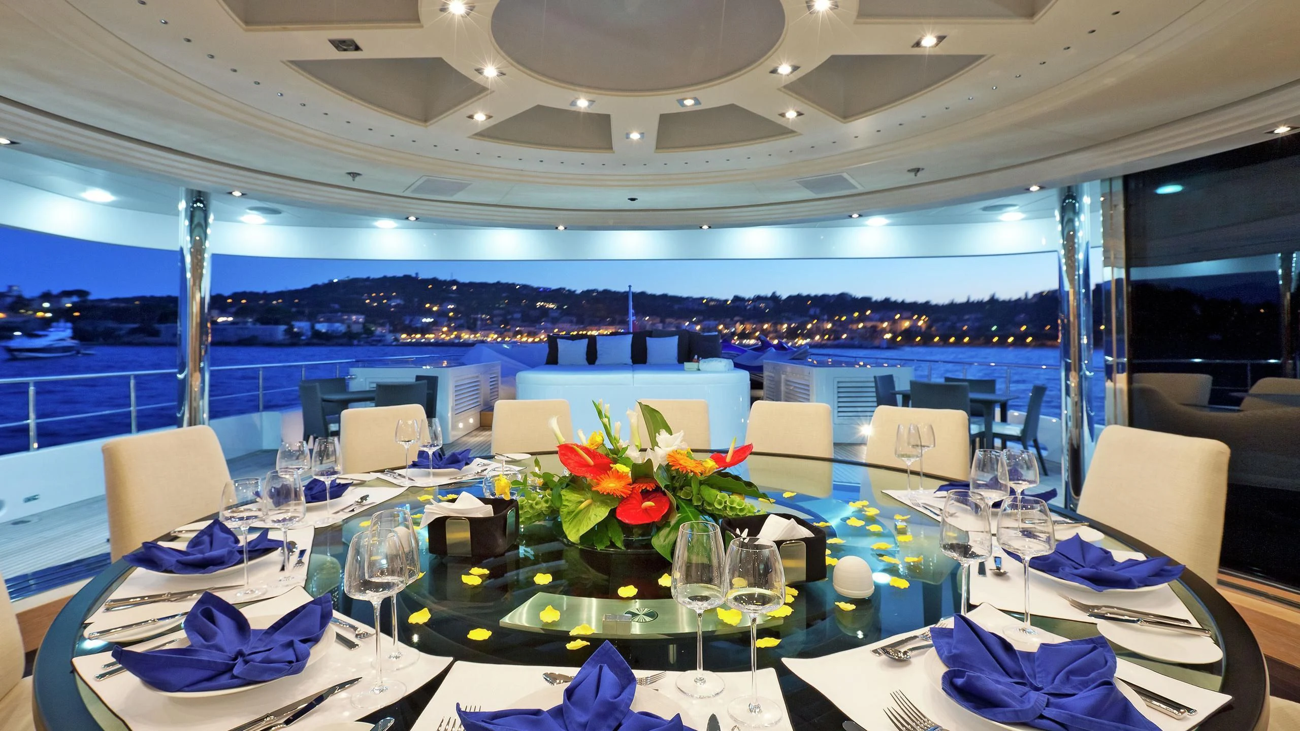 a table set with chairs and flowers aboard BELLA 2 Yacht for Sale
