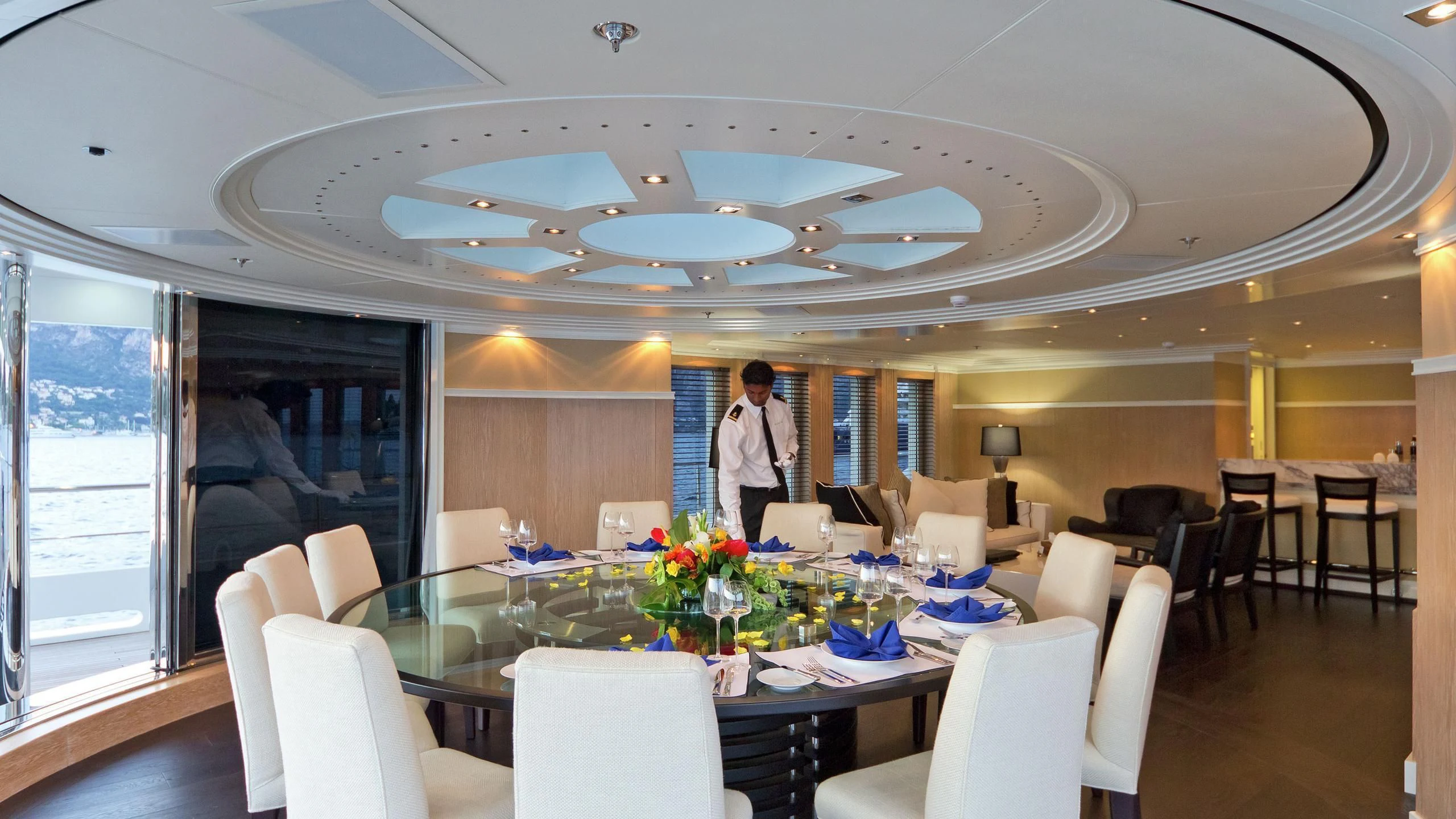 a person standing in a room with tables and chairs aboard BELLA 2 Yacht for Sale