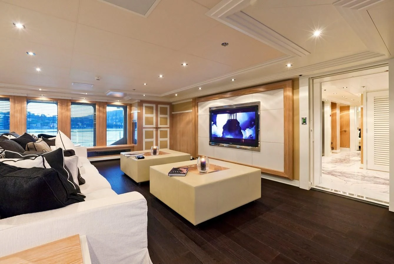 a living room with a large screen aboard BELLA 2 Yacht for Sale