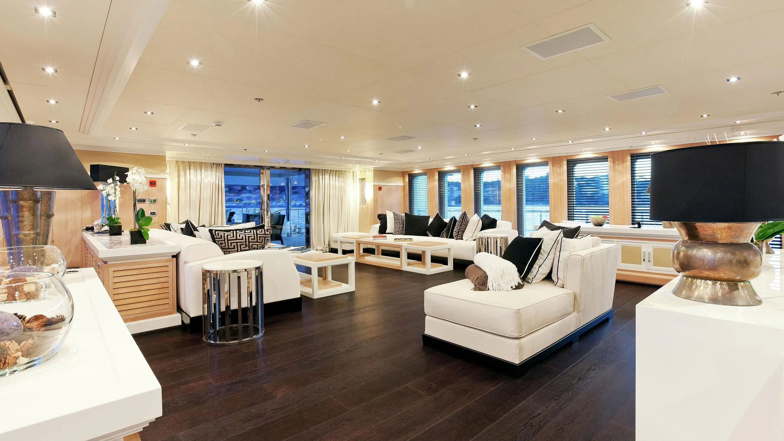 a living room with a large black lamp and white furniture aboard BELLA 2 Yacht for Sale