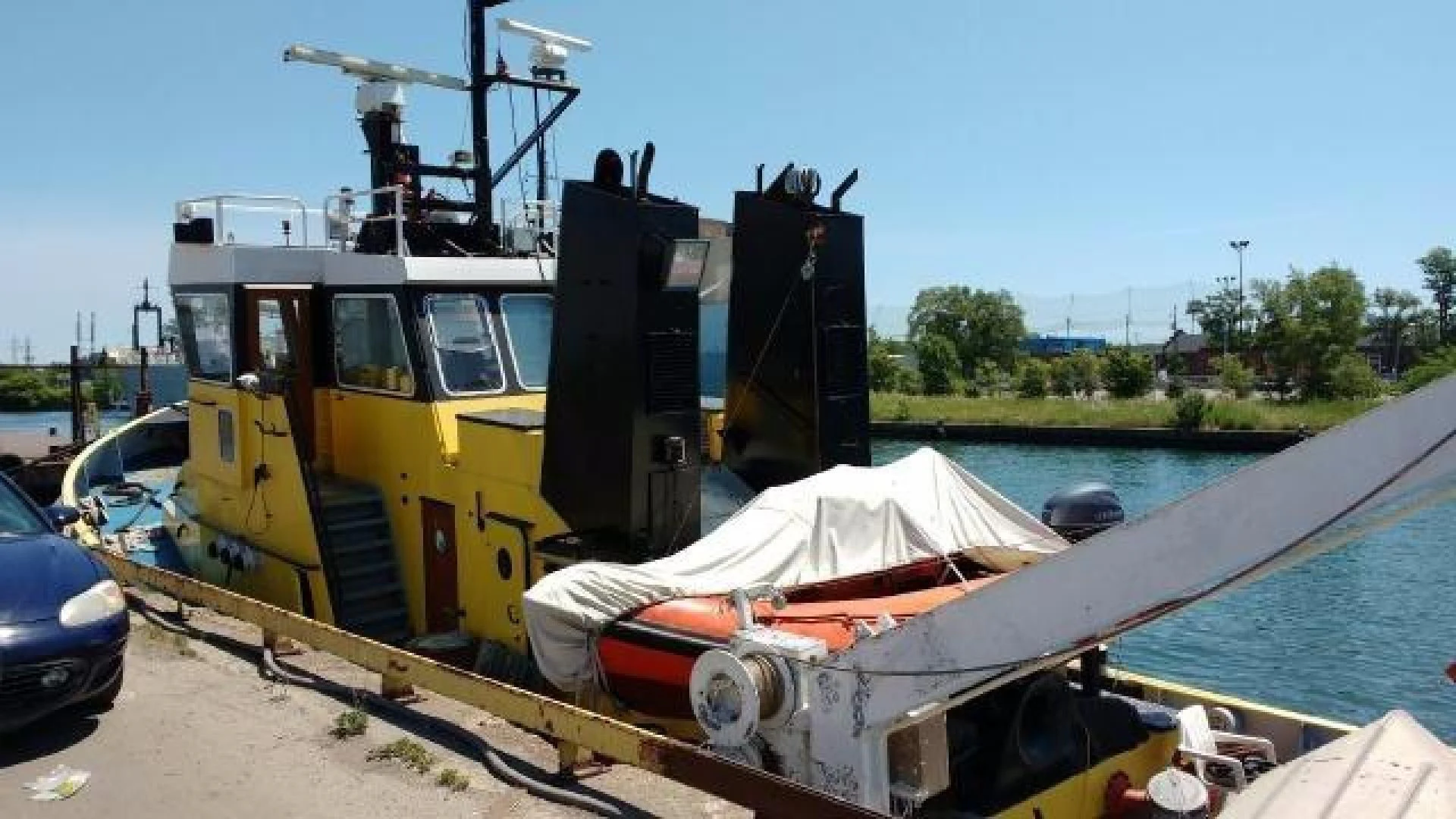 a large yellow machine on a dock aboard ITINERANTE I Yacht for Sale