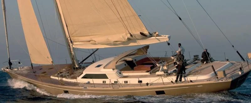a couple of people sailing on a sailboat aboard DHARMA Yacht for Sale