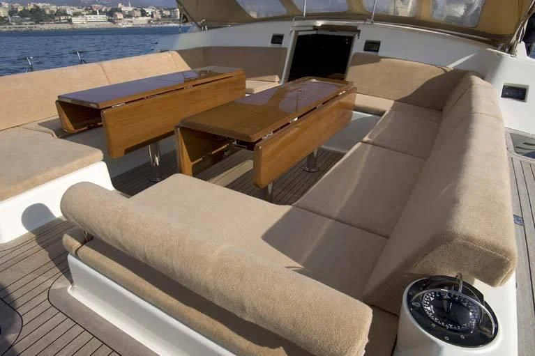 a couch with a table on it aboard DHARMA Yacht for Sale