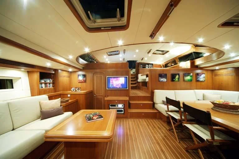 a room with a couch and a television aboard DHARMA Yacht for Sale