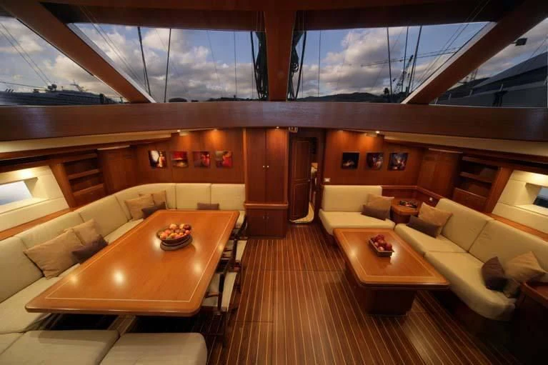a room with a table and couches aboard DHARMA Yacht for Sale