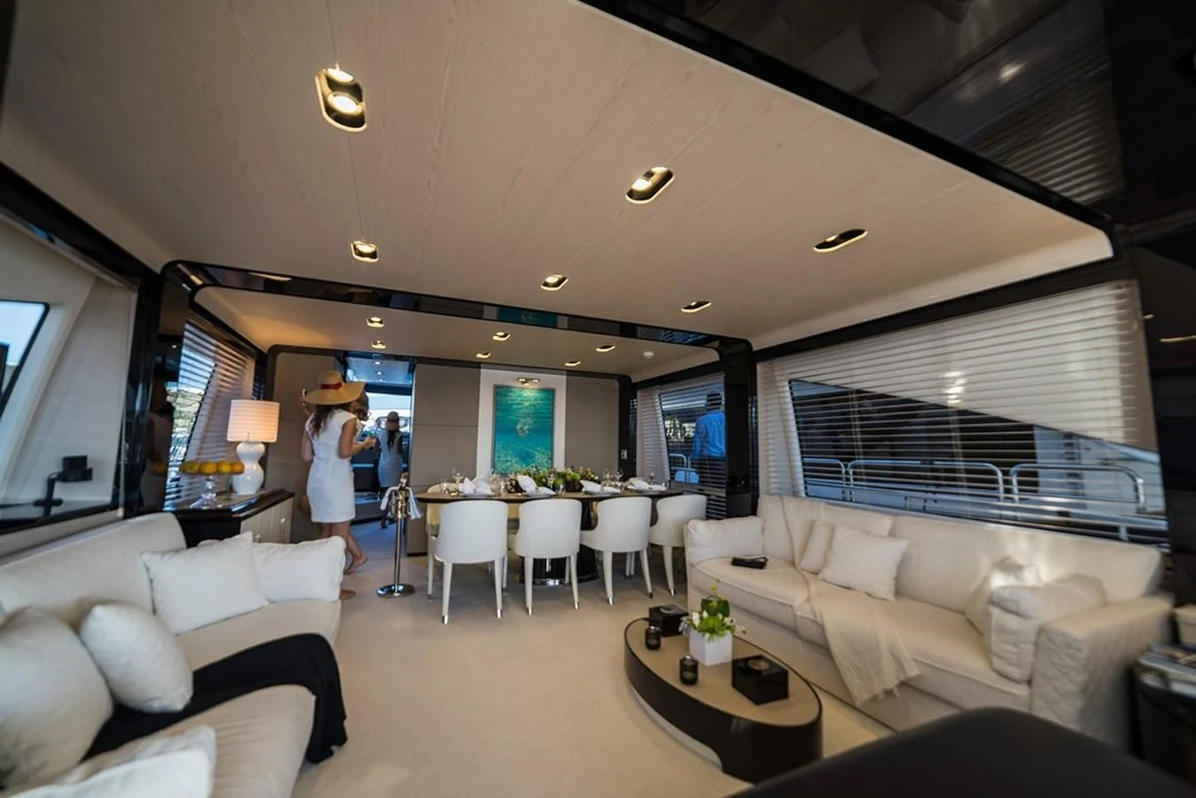 a room with a couch and a table and a couple of people aboard MEMORIES Yacht for Sale