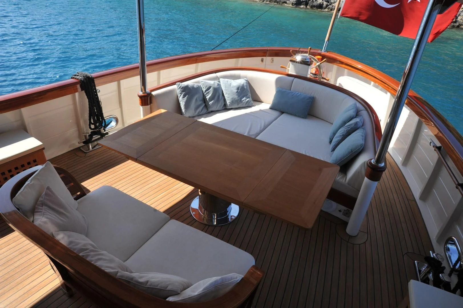 a bed with a white bed and a white chair on a deck aboard LARIMAR Yacht for Sale