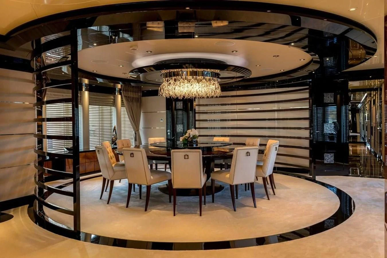 a room with a table chairs and a chandelier aboard TALISMAN C Yacht for Charter