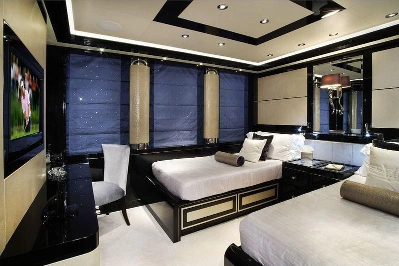 a room with a bed and a tv aboard TALISMAN C Yacht for Charter