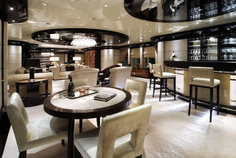 a room with a table chairs and a couch aboard TALISMAN C Yacht for Charter