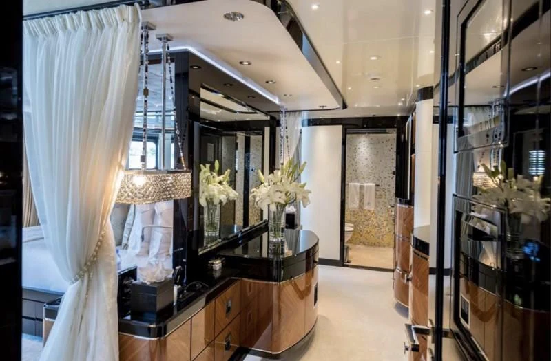 a room with a large mirror and vases of flowers aboard TALISMAN C Yacht for Charter