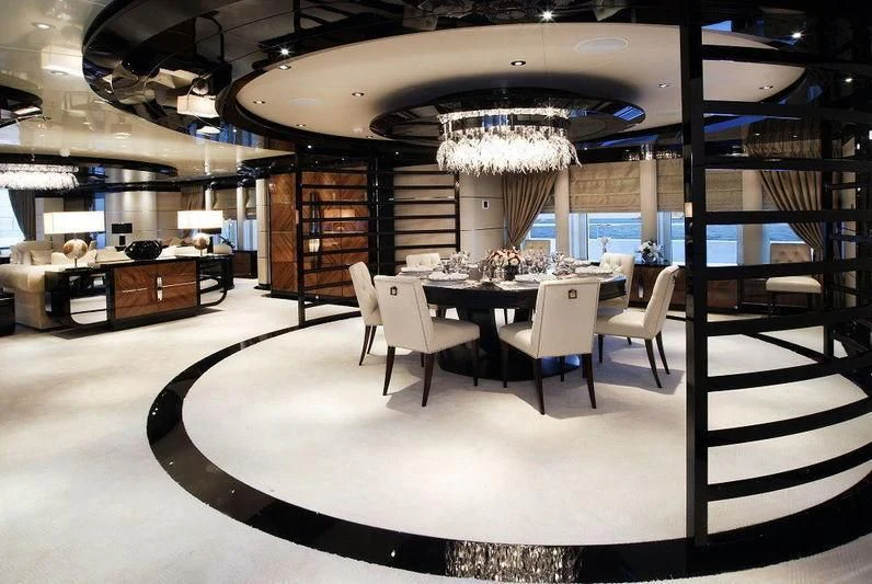 a room with a table chairs and a large window aboard TALISMAN C Yacht for Charter