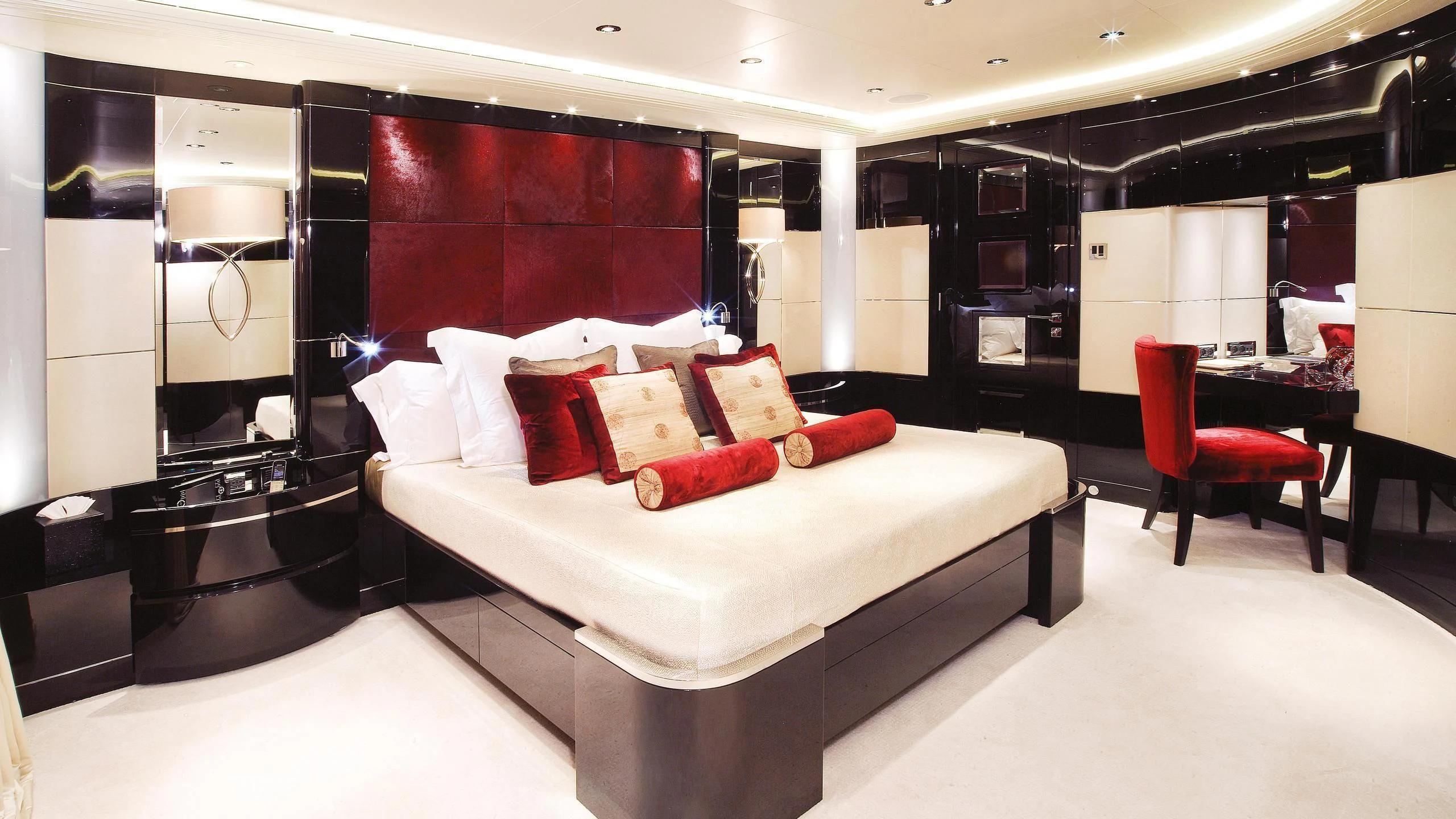 a room with a bed and a chair aboard TALISMAN C Yacht for Charter