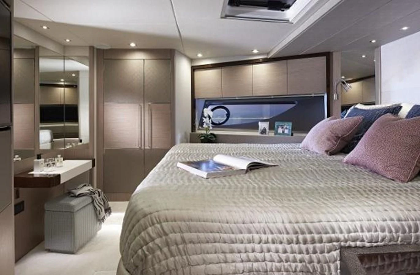 a bed with a white sheet and pink pillows aboard 76 YACHT Yacht for Sale