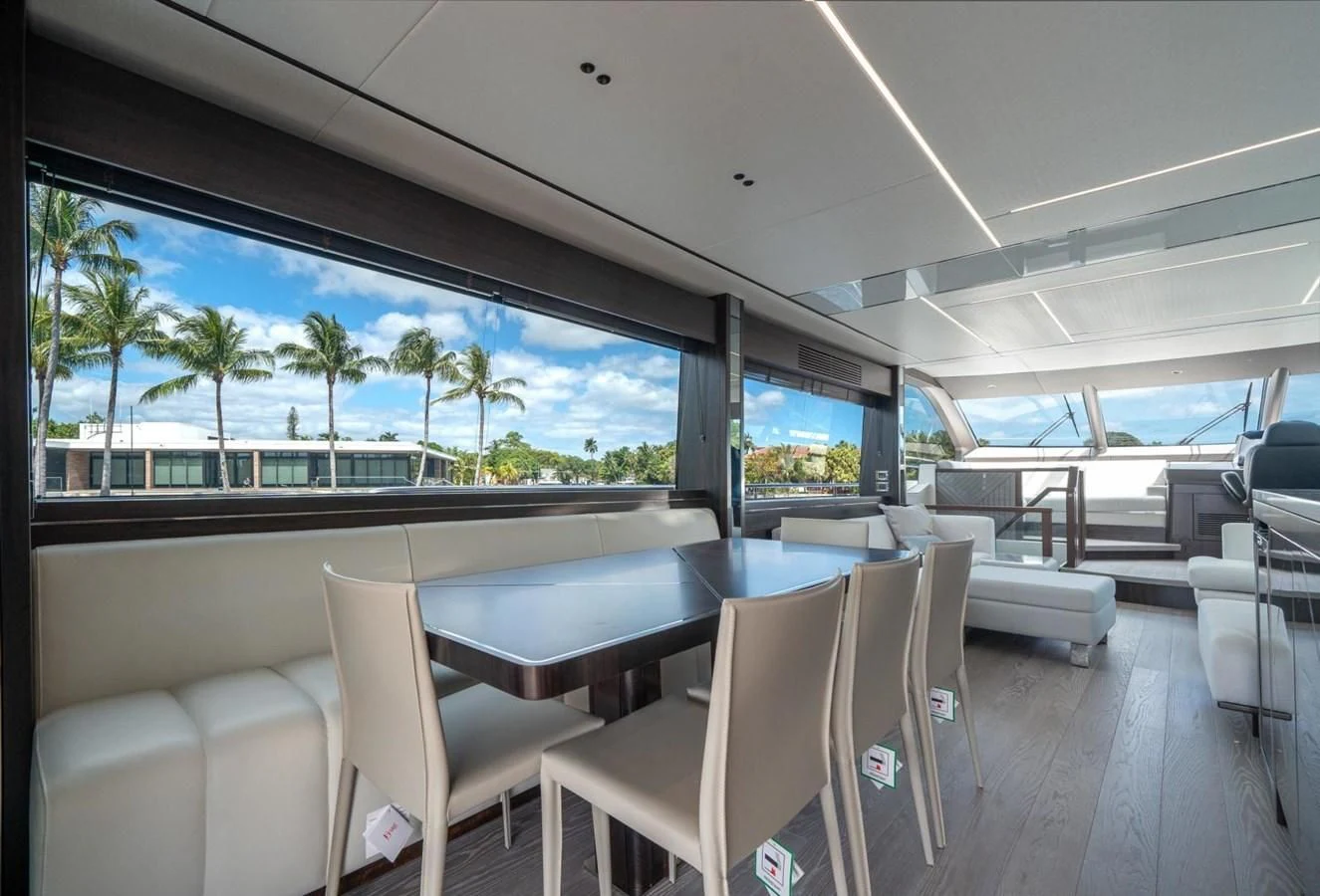 a room with a table chairs and a large window with a view of the ocean aboard 76 YACHT Yacht for Sale