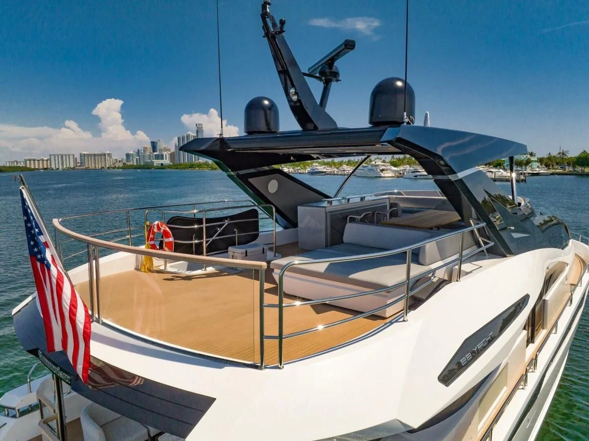 a boat with a flag on the front aboard 76 YACHT Yacht for Sale