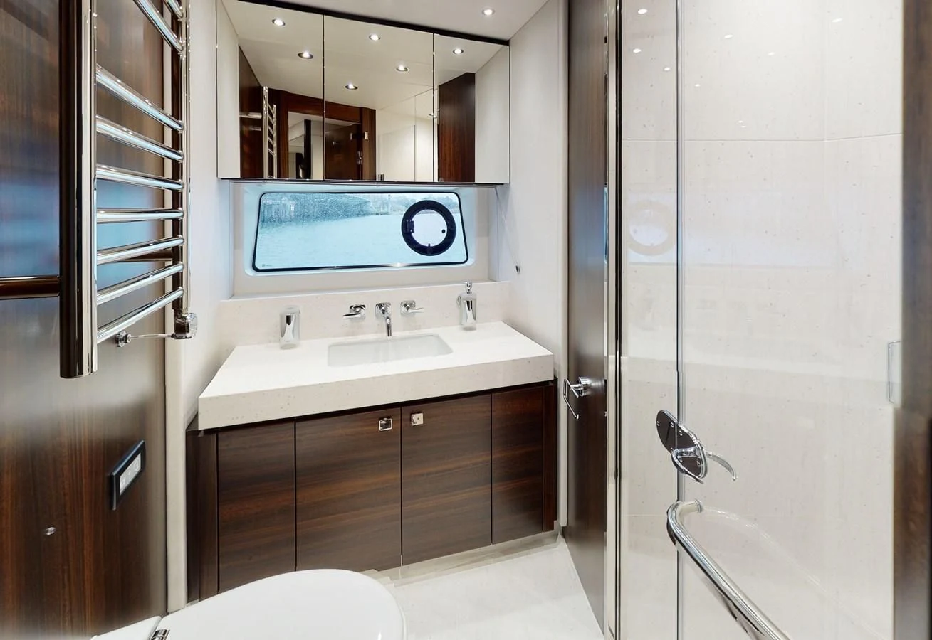 a bathroom with a sink and a tv aboard 76 YACHT Yacht for Sale