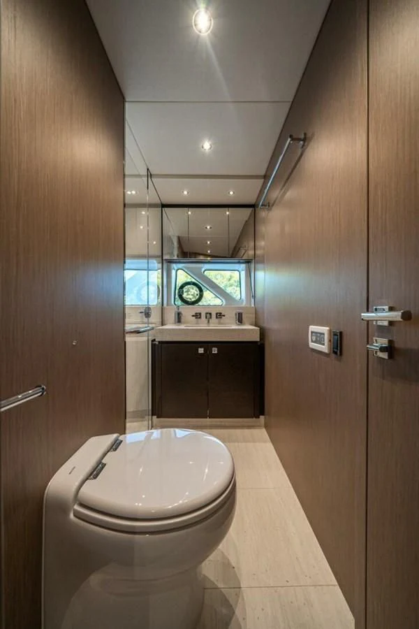 a bathroom with a toilet and sink aboard 76 YACHT Yacht for Sale
